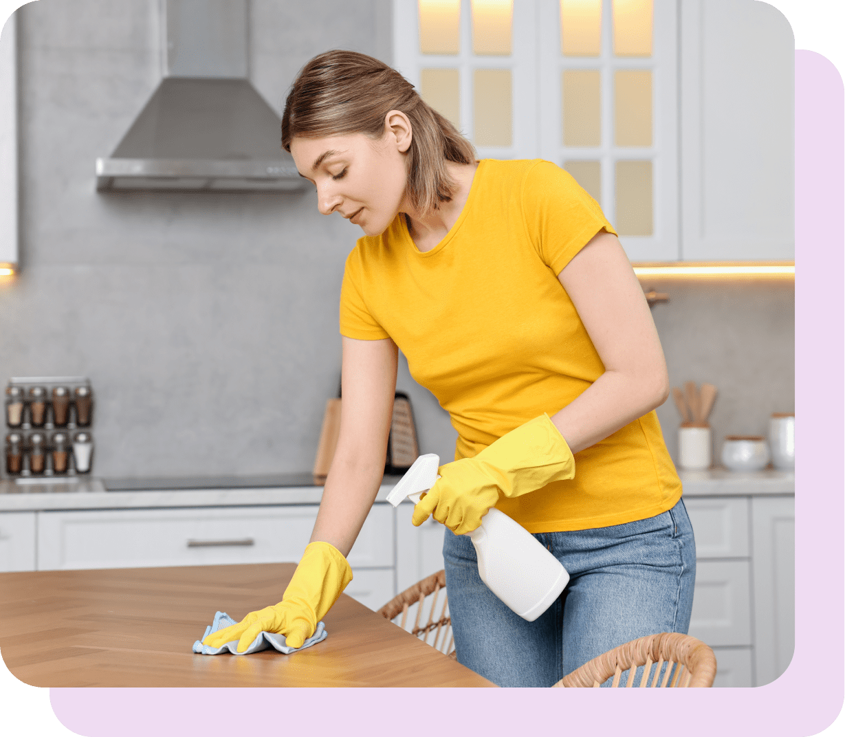 lady cleaning kitchen surfaces